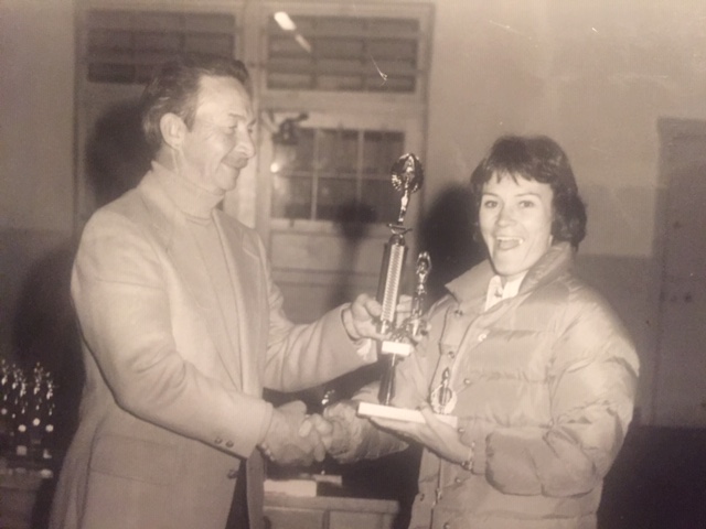 Carolyne West receiving trophy Carolyne West