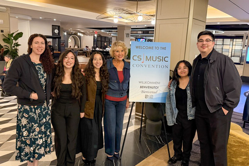 Hartnell College music students and faculty representatives pose beside a welcome sign at the 2026 Classical Singer Convention and Competition in Boston, where students participated in national vocal competitions, workshops, and networking events.