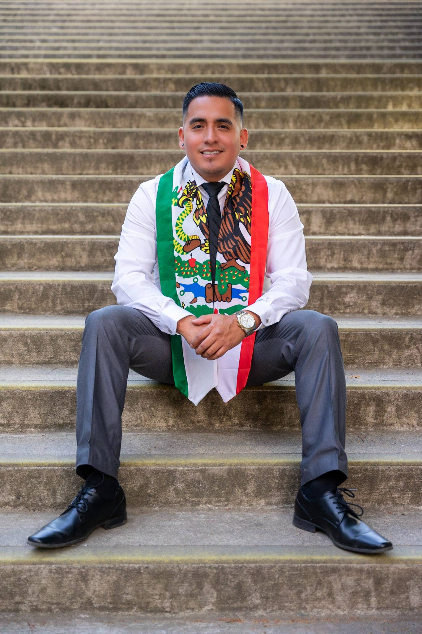 Julio Roman sitting on concrete steps 
